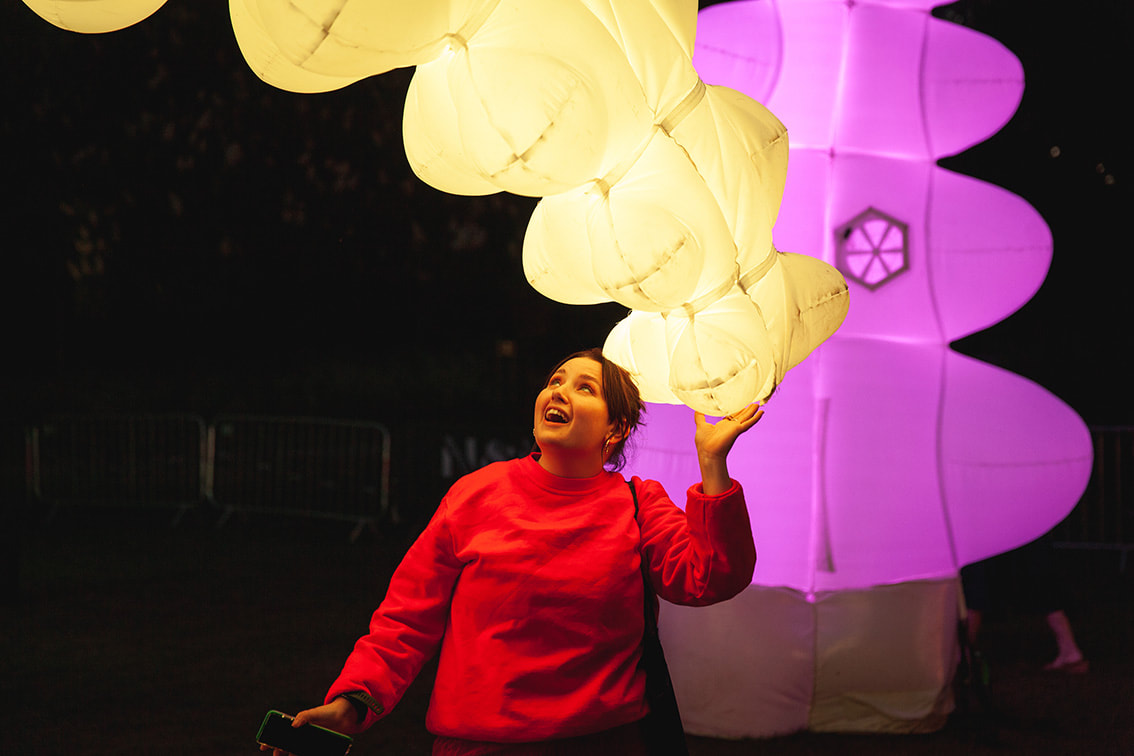 a woman interacting with one of Air Giant's soft robots