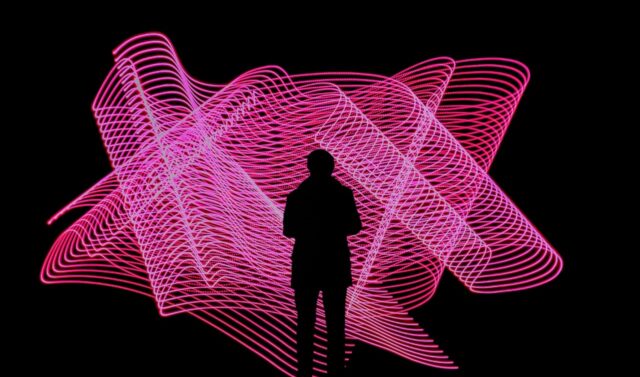 silhouetted figure against pink light