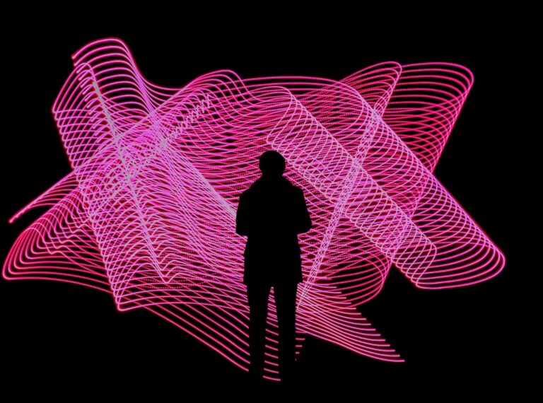 silhouetted figure against pink light