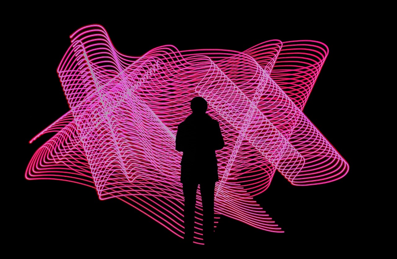 silhouetted figure against pink light