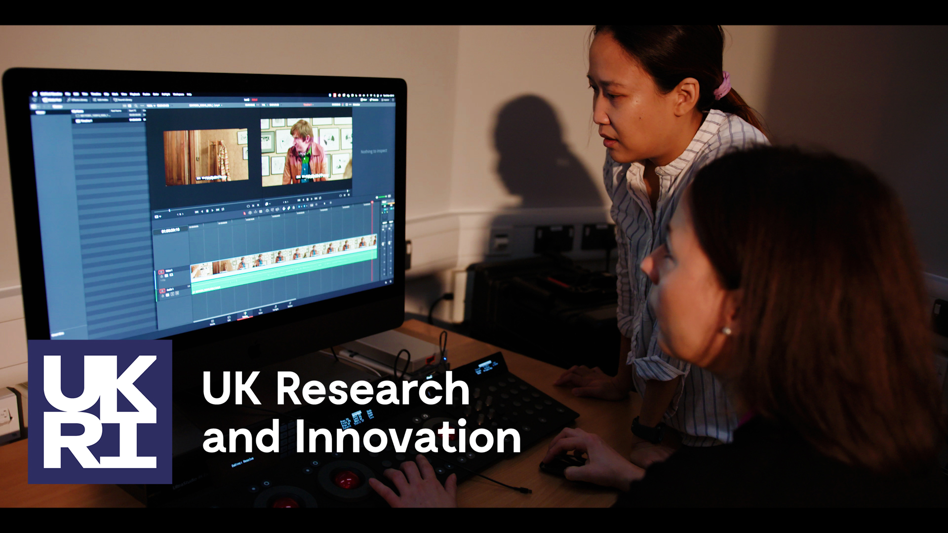 Two women editing footage at a computer