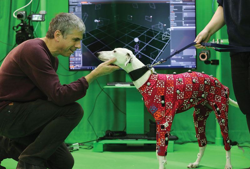 Man with dog a dog wearing motion capture suit