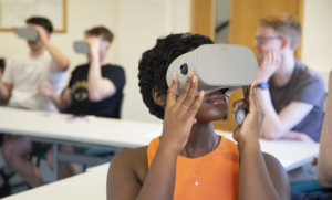 A woman wearing a VR headset wearing an orange vest looking upwards