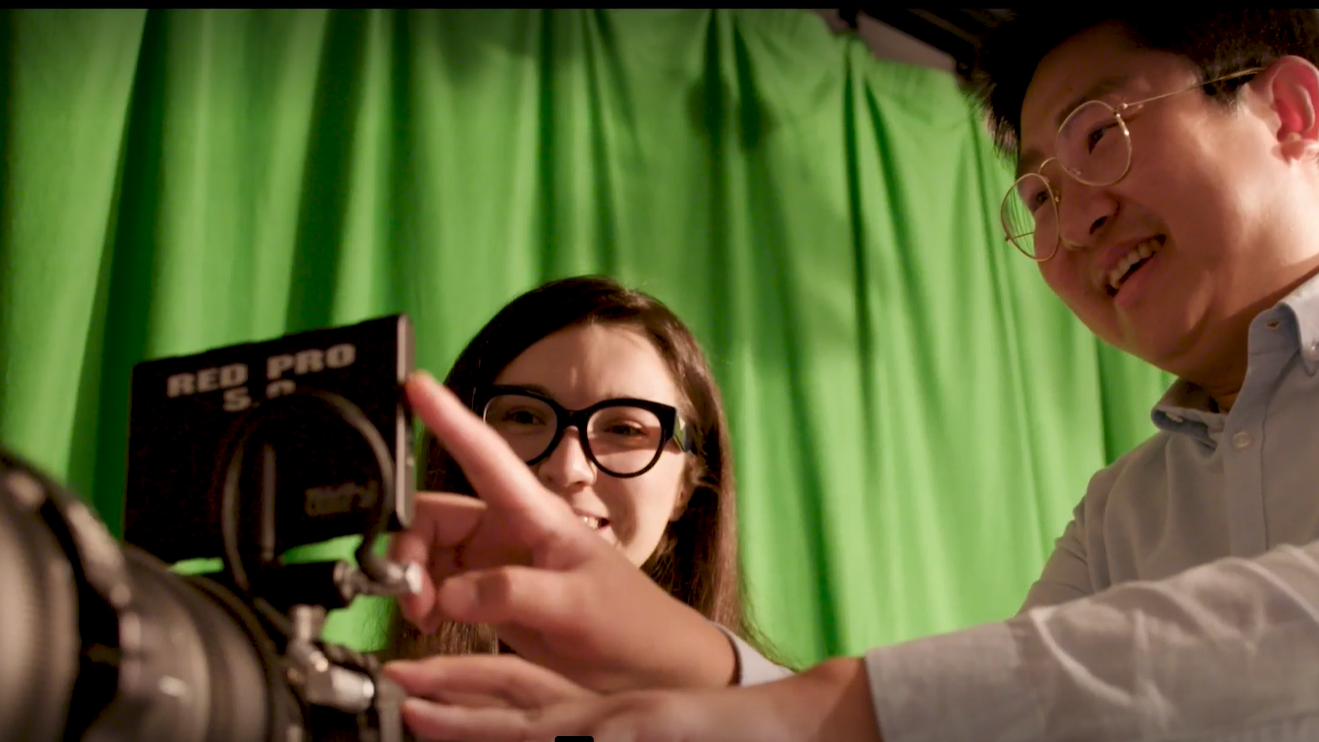 Two people looking at a camera screen