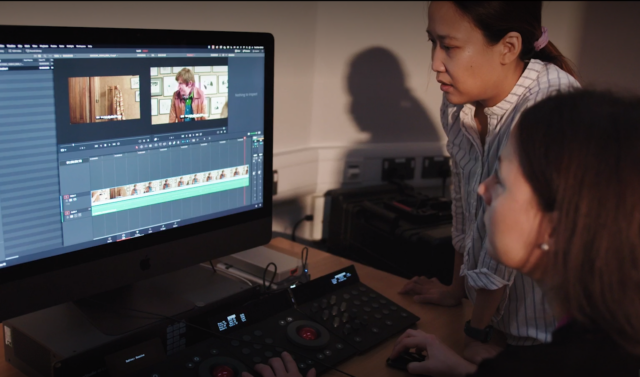 Two women editing footage at a computer