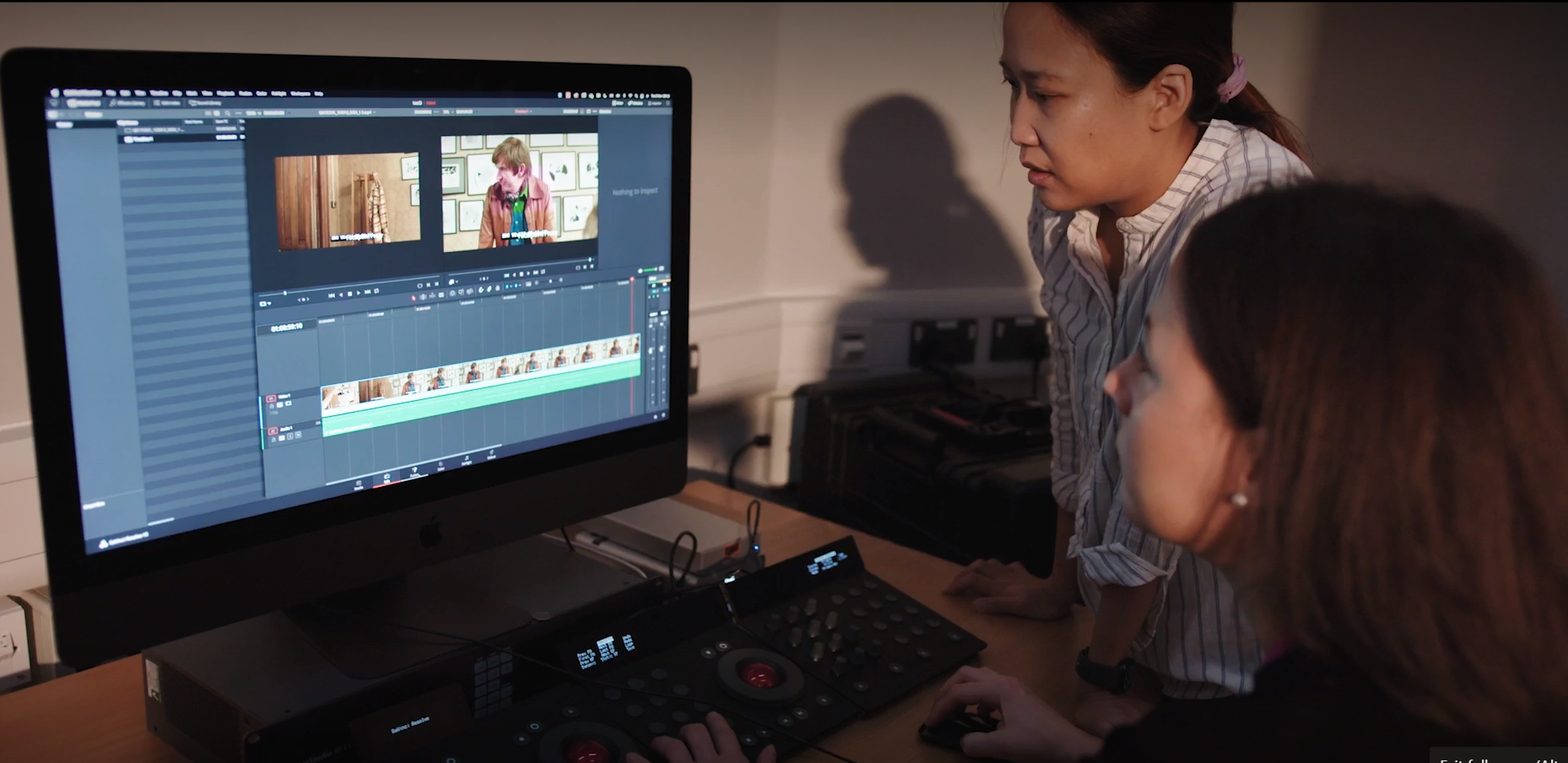 Two women editing footage at a computer