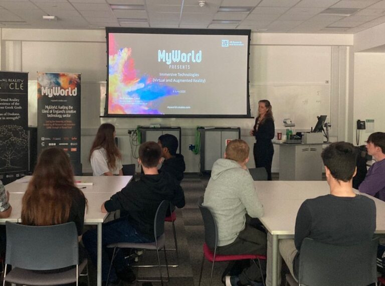 Students watching Ki Cater deliver presentation