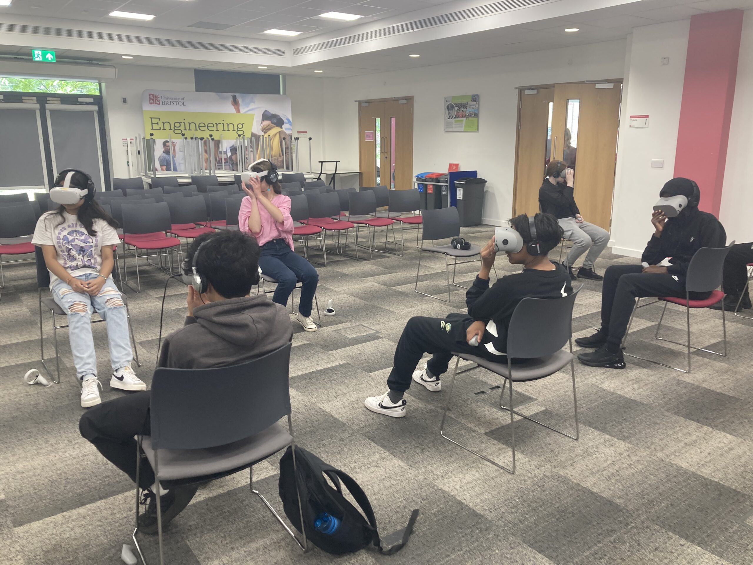 Group of Yr10s sat in a row wearing VR headsets