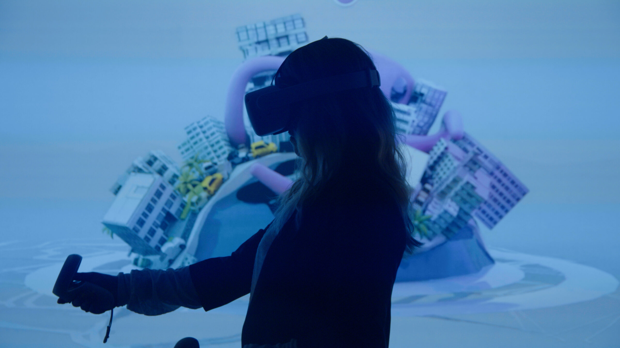 silhouette of woman using VR head set and controller