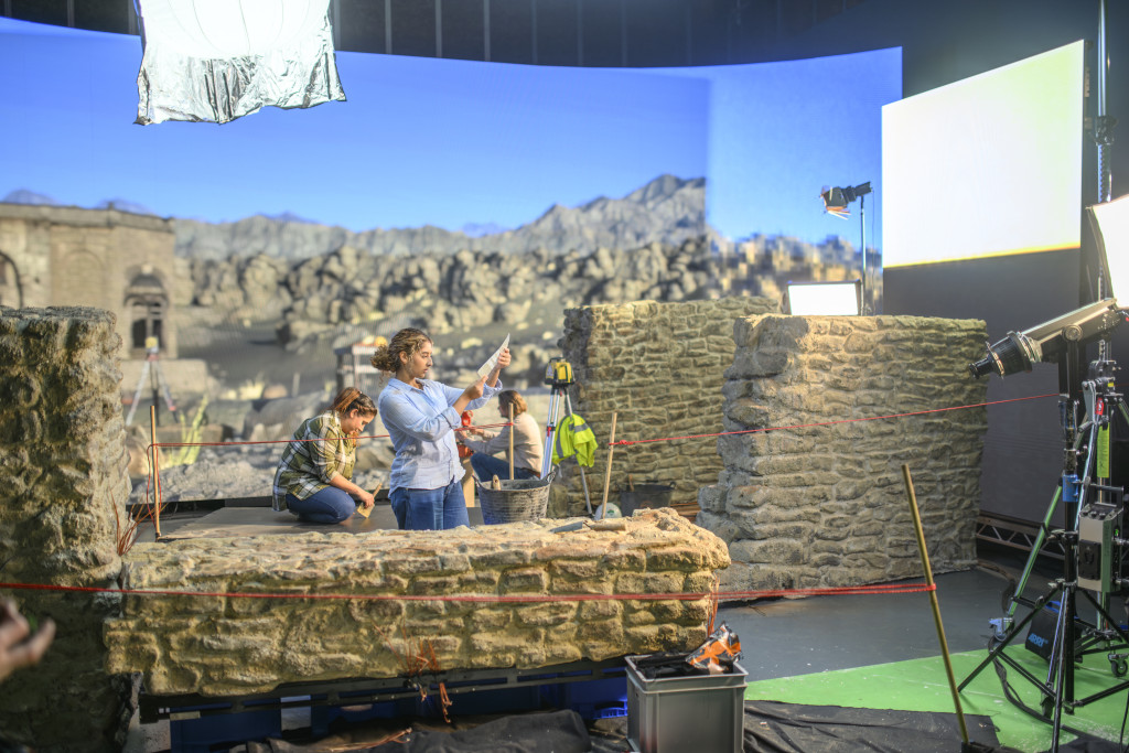 An image of a film set in front of a virtual production screen.