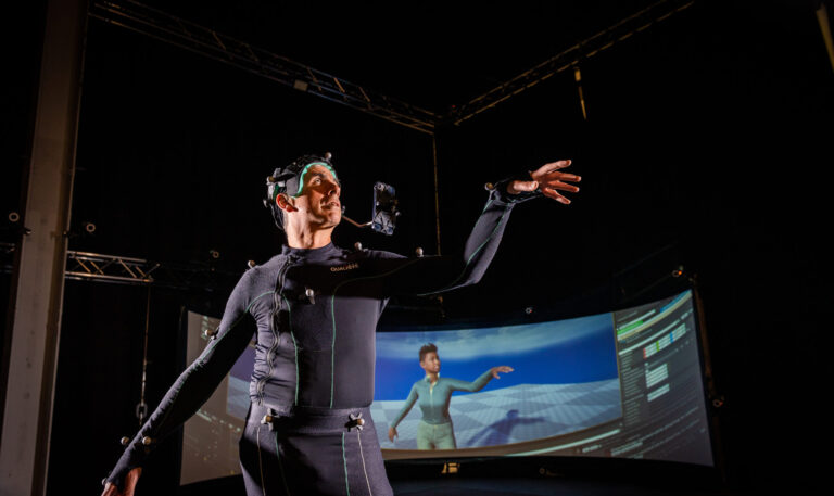 An image of a man in CAMERA's face and body light stage and photogrammetry rig.